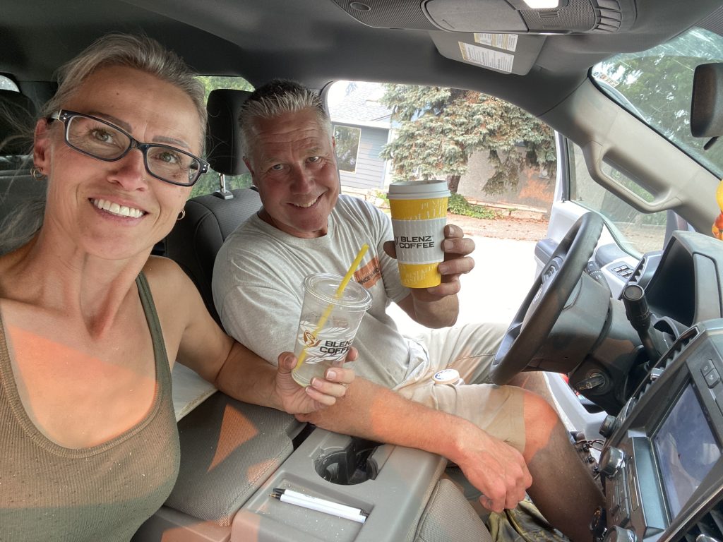 Christine and Steve Grouhel with coffees en route to a vinyl fence installation