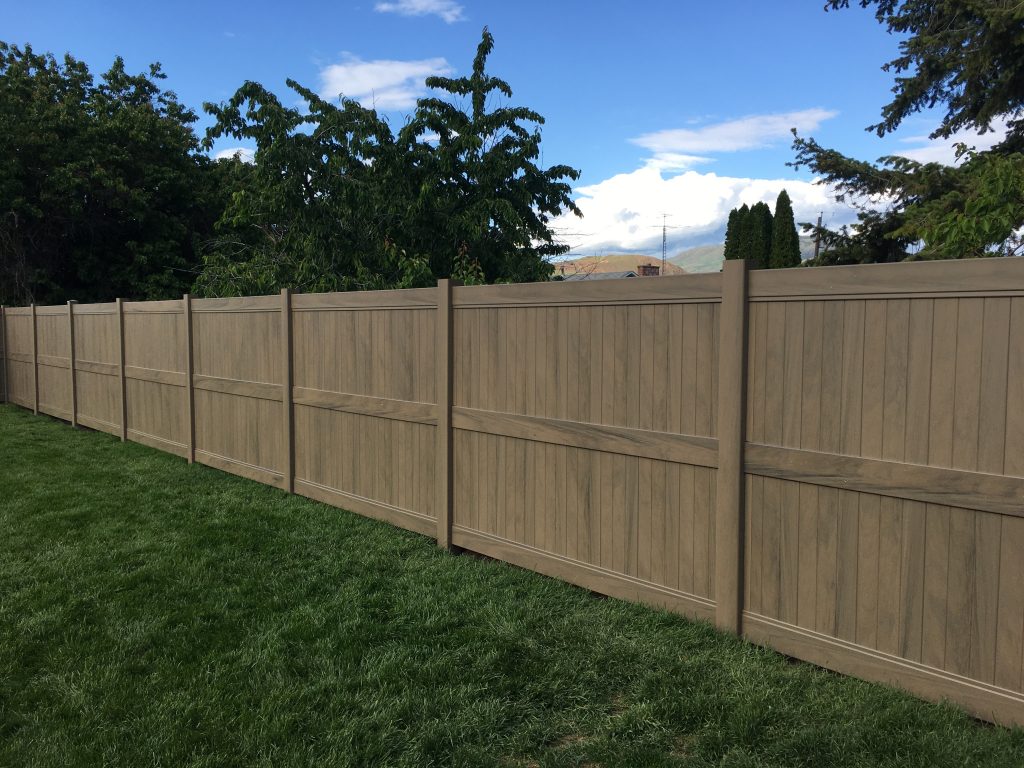 Boreal Dark Maple vinyl fence installation on lush green grass